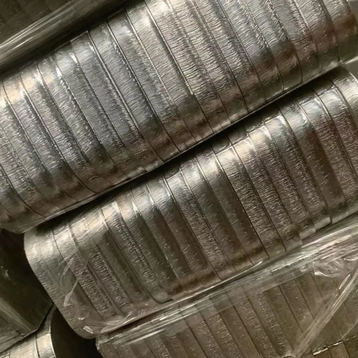 Batch of stacked stainless steel medium plate rectangular blanks with rounded corners