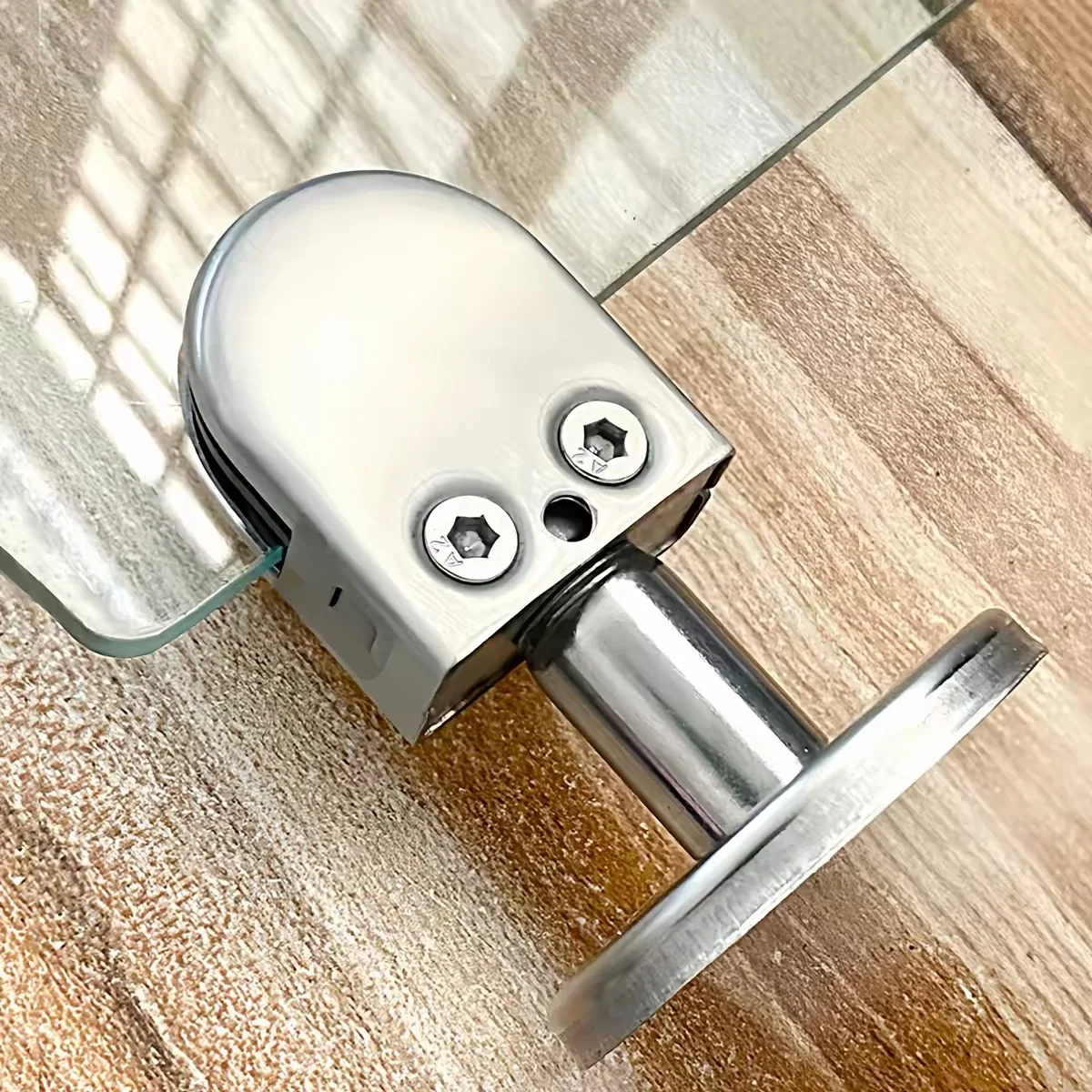 Mounted stainless steel wall-to-glass clamp and circular base plate